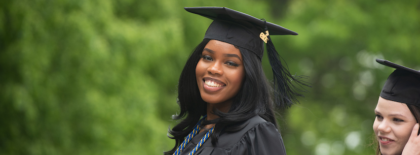 SCSU student at Commencement smiling at camera