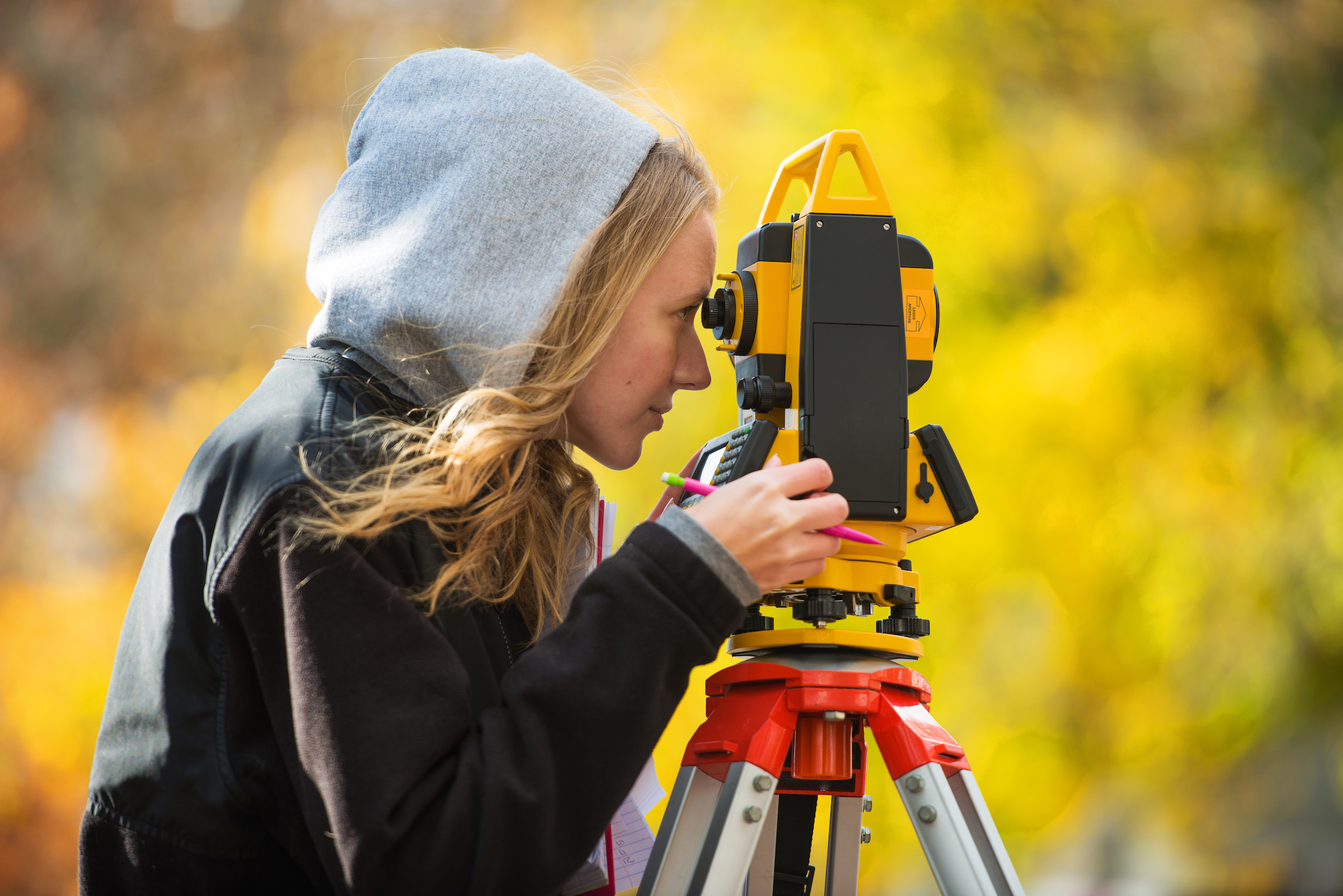 SCSU student outside looking at a telescope