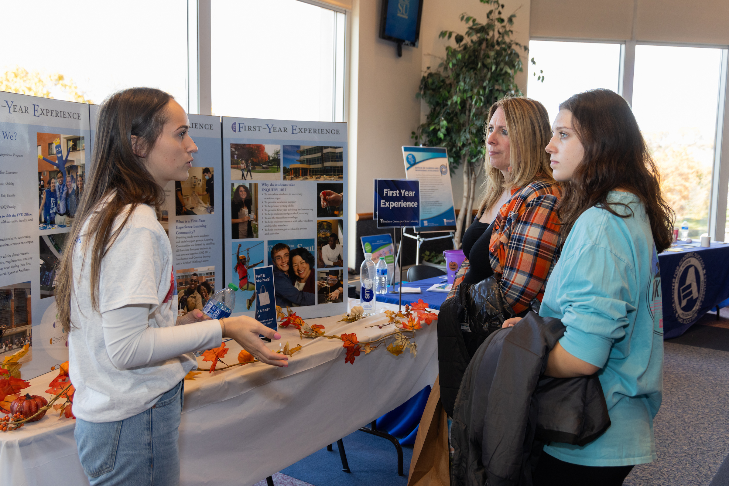 Student with her parents discussing with a college professional