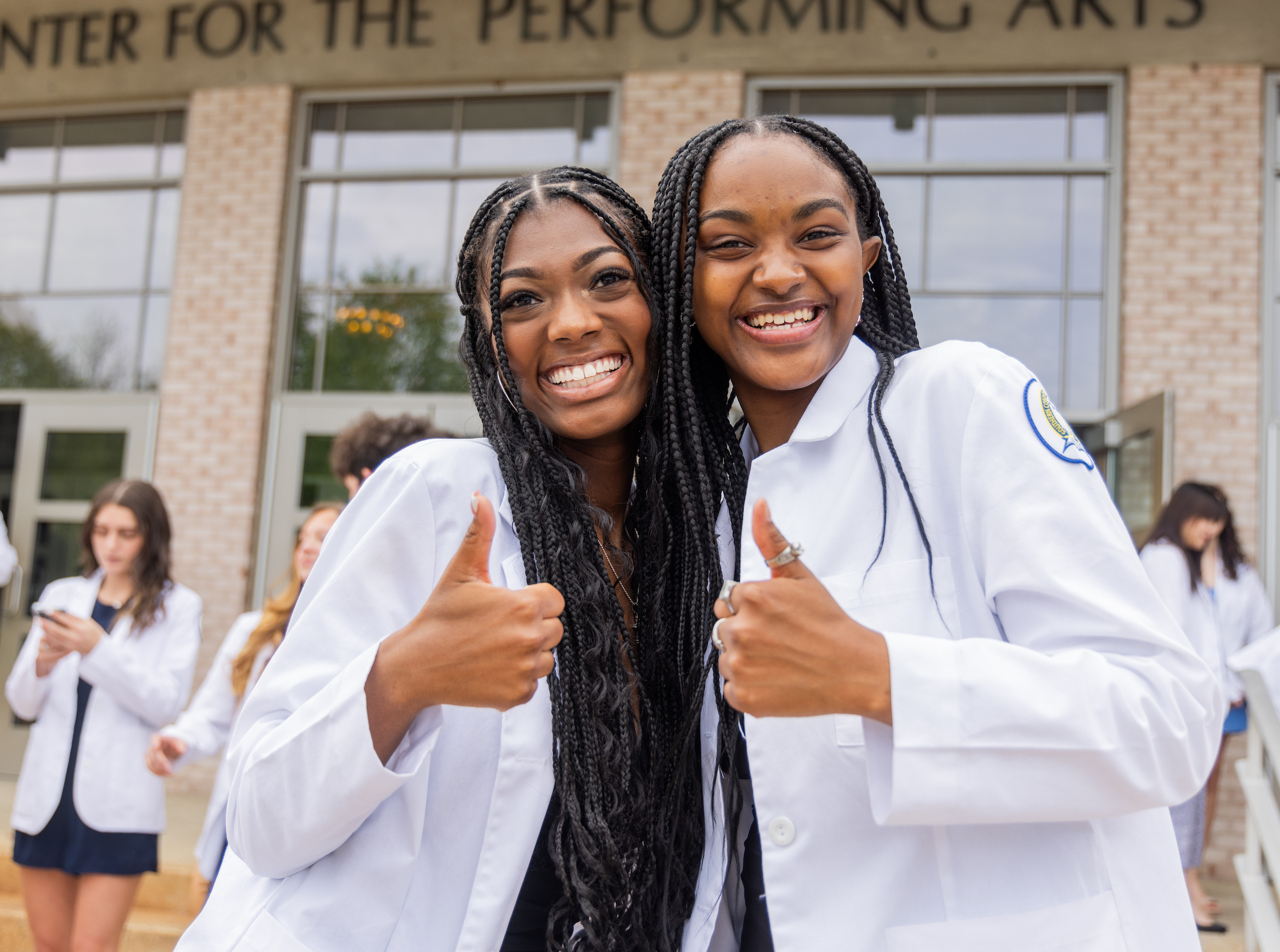 Nursing students smiling at the camera.